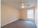 Light bedroom with neutral walls, carpeted floor, a ceiling fan, and window providing natural light at 1530 Monica St, Deltona, FL 32725