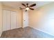 Bedroom featuring neutral walls, carpeted floors, ceiling fan, and a closet at 1530 Monica St, Deltona, FL 32725