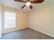 Bedroom featuring neutral walls, carpeted floors, and a window for natural light at 1530 Monica St, Deltona, FL 32725