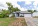 Exterior view of home with a gray facade, white trim, and a well-manicured lawn at 1530 Monica St, Deltona, FL 32725