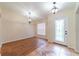Welcoming foyer featuring elegant lighting, a decorative front door, and a mix of tile and wood flooring at 1530 Monica St, Deltona, FL 32725