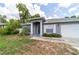 View of the front exterior highlighting a modern home with a well-maintained lawn at 1530 Monica St, Deltona, FL 32725