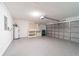 Attached two-car garage with epoxy floors, workbench, shelving, and overhead storage at 1530 Monica St, Deltona, FL 32725