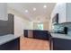 Modern kitchen featuring stainless steel appliances, granite countertops, and a stylish blue backsplash at 1530 Monica St, Deltona, FL 32725