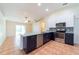 Well-lit kitchen featuring stainless steel appliances and ample counter space for meal preparation at 1530 Monica St, Deltona, FL 32725