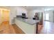 An open-concept kitchen with granite countertops, and stainless steel refrigerator at 1530 Monica St, Deltona, FL 32725
