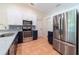 Bright kitchen with stainless steel appliances, white cabinets and blue backsplash at 1530 Monica St, Deltona, FL 32725