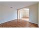 Inviting living room featuring wood floors and an archway to the dining area at 1530 Monica St, Deltona, FL 32725