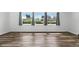 Bright living room with wood-look floors and multiple windows offering a serene view at 161 Peacock, Altamonte Springs, FL 32701