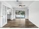 Open-concept living area with wood-look floors, leading to a pool through sliding glass doors at 161 Peacock, Altamonte Springs, FL 32701