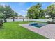 Expansive backyard features a pool, jacuzzi, brick patio, green lawn, and white fence at 1620 S Eola Dr, Orlando, FL 32806
