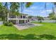 Beautiful backyard with pool, jacuzzi, brick patio, and lush green lawn at 1620 S Eola Dr, Orlando, FL 32806