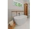 Bright bathroom with soaking tub and hardwood shelves at 1620 S Eola Dr, Orlando, FL 32806