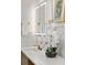 Close up of vanity in primary bathroom showing double sinks, LED mirror, and orchid at 1620 S Eola Dr, Orlando, FL 32806