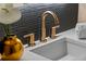 Close up of elegant bathroom sink with gorgeous gold fixtures and modern design at 1620 S Eola Dr, Orlando, FL 32806