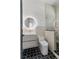 Modern bathroom with patterned floor, glass shower, round lighted mirror, and floating vanity at 1620 S Eola Dr, Orlando, FL 32806