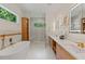 Modern bathroom with a soaking tub, walk-in shower, and double sink vanity at 1620 S Eola Dr, Orlando, FL 32806