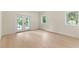 Sun-filled bedroom with light wood floors and access to private balcony at 1620 S Eola Dr, Orlando, FL 32806