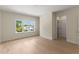Light-filled bedroom featuring light wood floors, large window and white trim at 1620 S Eola Dr, Orlando, FL 32806