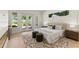 Bright bedroom with a stylish rug, fireplace, and doors to a backyard patio at 1620 S Eola Dr, Orlando, FL 32806