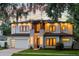 Striking two-story home with ambient outdoor lighting, complemented by a brick driveway and a well-manicured front lawn at 1620 S Eola Dr, Orlando, FL 32806