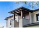 Architectural detail showcases the home's covered entry with wooden accents and brick support columns at 1620 S Eola Dr, Orlando, FL 32806