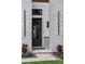 A stunning front door with geometric design framed by brick columns and sconce lighting at 1620 S Eola Dr, Orlando, FL 32806