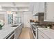 Bright, modern kitchen with white cabinetry, an island, and stainless steel appliances at 1620 S Eola Dr, Orlando, FL 32806