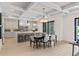 Open-concept kitchen and dining area featuring an island with seating, adjacent to a dining table at 1620 S Eola Dr, Orlando, FL 32806
