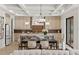 Bright kitchen and dining area with custom cabinetry, island seating, and modern lighting at 1620 S Eola Dr, Orlando, FL 32806