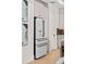 Modern white refrigerator with bronze accents in a bright, open kitchen with wood floors at 1620 S Eola Dr, Orlando, FL 32806