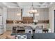 Kitchen and dining area featuring an island with seating and designer pendant lighting above the island at 1620 S Eola Dr, Orlando, FL 32806