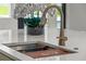 Detailed view of a modern kitchen sink with a cutting board and gold faucet at 1620 S Eola Dr, Orlando, FL 32806