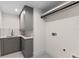 Well-lit laundry room features stylish gray cabinetry, modern fixtures, and patterned tile flooring at 1620 S Eola Dr, Orlando, FL 32806