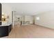 Bright upstairs living area with light wood floors, a wet bar, and access to other rooms at 1620 S Eola Dr, Orlando, FL 32806