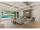 Bright living room featuring modern fireplace, wood accent wall, coffered ceiling, and sliding doors to the pool at 1620 S Eola Dr, Orlando, FL 32806