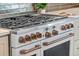 Close up of a white oven with bronze handles and knobs; part of a modern kitchen appliance set at 1620 S Eola Dr, Orlando, FL 32806