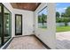 Outdoor patio features brick flooring, modern window view, and a dark wood-paneled ceiling at 1620 S Eola Dr, Orlando, FL 32806