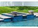 Beautiful backyard pool and spa featuring tiered tilework and elegant fire bowls at 1620 S Eola Dr, Orlando, FL 32806
