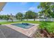 Landscaped backyard featuring a pool with a spa, fire bowls, and well-manicured lawn at 1620 S Eola Dr, Orlando, FL 32806