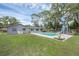Outdoor pool with a slide features a spacious green lawn, perfect for relaxing and enjoying the outdoors at 223 Royal Oaks Cir, Longwood, FL 32779