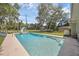 A refreshing inground pool is surrounded by a concrete patio, lush lawn and a shed in a private backyard at 223 Royal Oaks Cir, Longwood, FL 32779