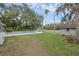 A fenced-in pool with an slide is complemented by lush green grass and a quaint storage shed at 223 Royal Oaks Cir, Longwood, FL 32779