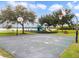 A basketball court is located next to a playground, picnic tables, and lake views for community recreation at 223 Royal Oaks Cir, Longwood, FL 32779
