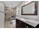 Modern bathroom with large framed mirror, stylish vanity with marble countertop, and tiled walk-in shower at 223 Royal Oaks Cir, Longwood, FL 32779