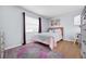 Comfortable bedroom featuring a plush bed, wooden floors, a large window, and charming decor at 223 Royal Oaks Cir, Longwood, FL 32779