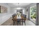 Bright dining room boasts modern light fixture, neutral walls, and large window view at 223 Royal Oaks Cir, Longwood, FL 32779
