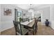 Elegant dining room with stylish chandelier, wainscoting, and a large window at 223 Royal Oaks Cir, Longwood, FL 32779