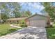 Charming one-story brick home with well-manicured lawn, mature trees, and a two-car garage at 223 Royal Oaks Cir, Longwood, FL 32779