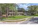 Inviting one-story brick home with lush lawn, mature trees, and a serene neighborhood setting at 223 Royal Oaks Cir, Longwood, FL 32779